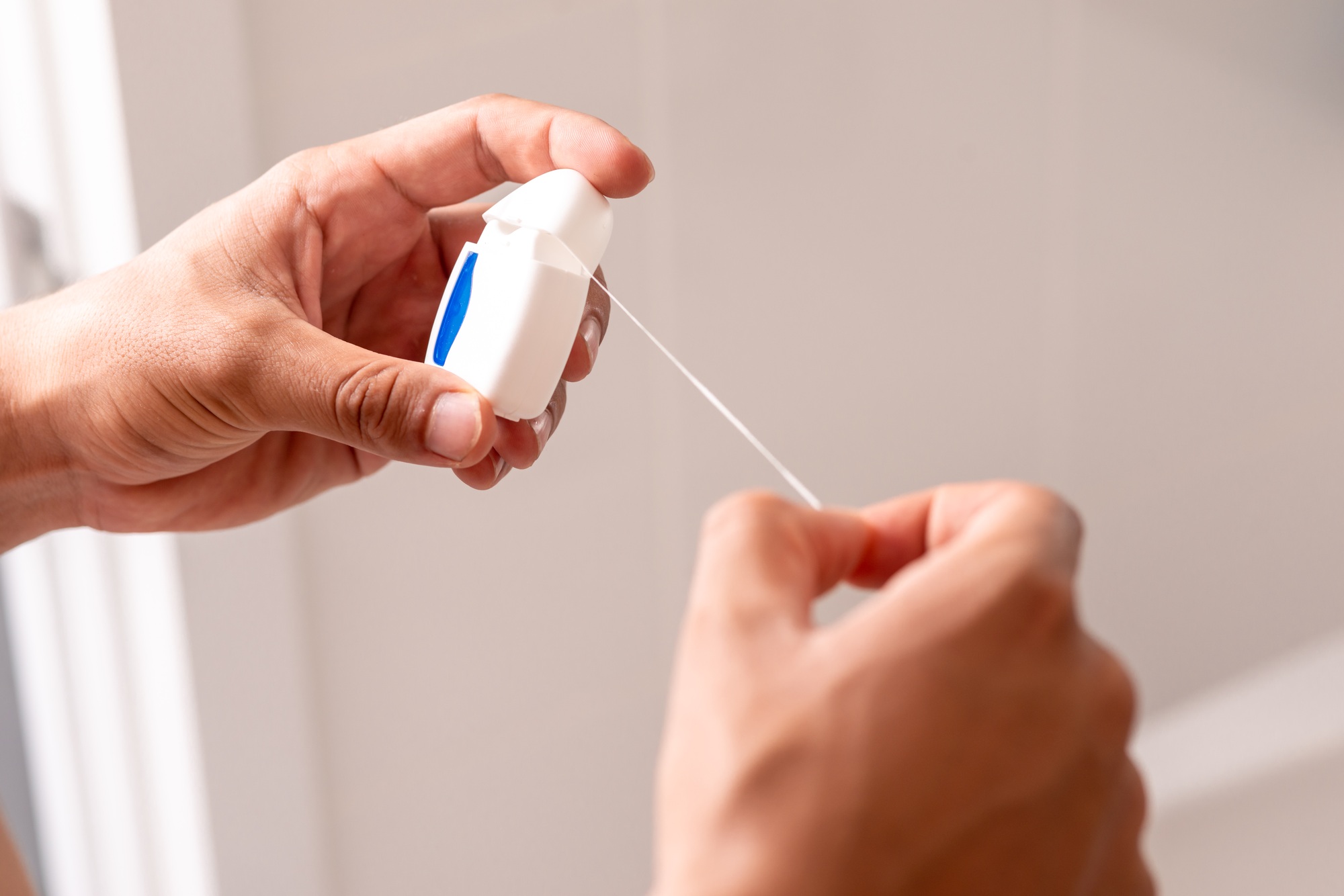 Your teeth needs me. Dental floss in hands. Teeth care.
